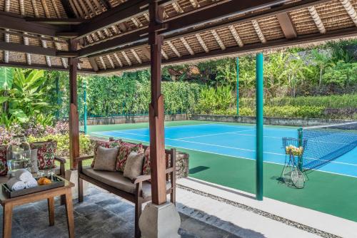 a tennis court is seen from the patio of a villa at Four Seasons Resort Bali at Jimbaran Bay in Jimbaran
