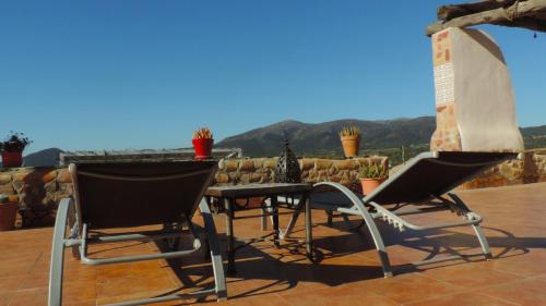 two chairs and a table on a patio at Brisa in Oria