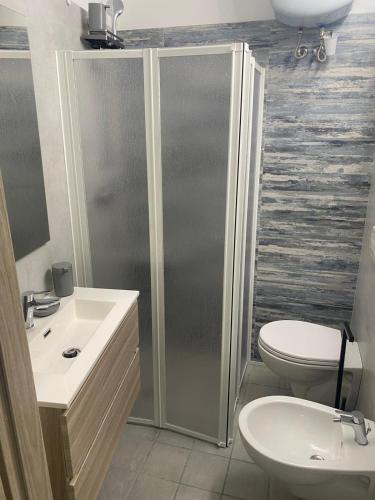 a bathroom with a shower and a toilet and a sink at B&B al Vicoletto in Bellante