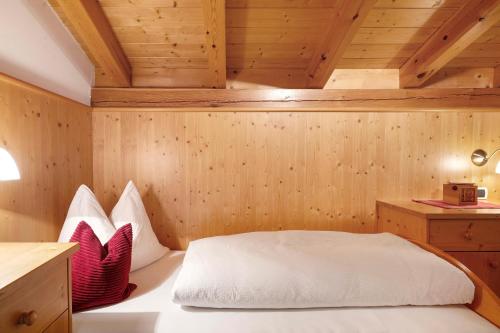 a room with a bed in a wooden room at Prackfolerhof in Fie allo Sciliar