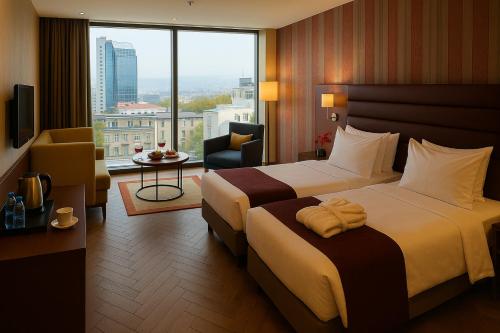 a hotel room with two beds and a large window at Taksim Gonen Hotel in Istanbul
