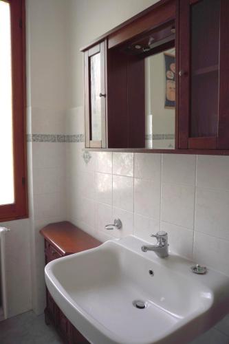 a bathroom with a white sink and a mirror at Casa Castagno e Ruscello - Nature Retreat in Liguria in Pieve di Teco