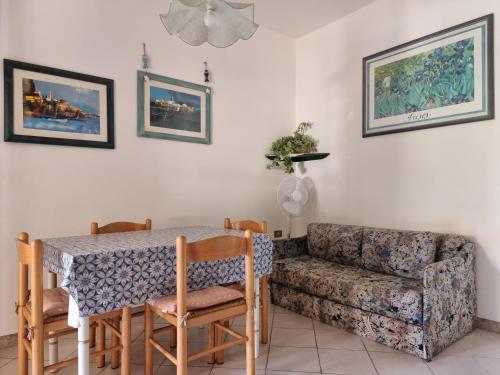 a living room with a table and a couch at Residenze Lu Rinaggiu in Agrustos