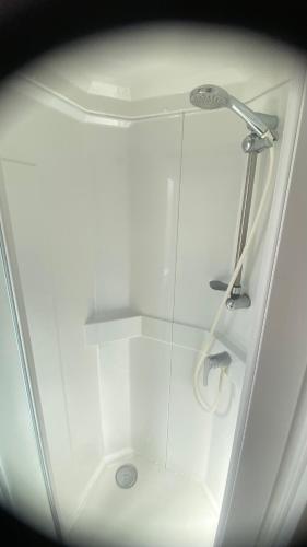 a bathroom with a shower with a glass wall at Posada IRIS in Puerto Lápice