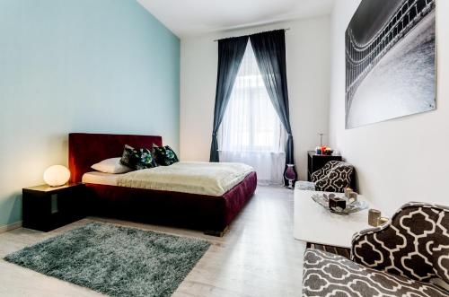 a bedroom with a large bed and a large window at Central Stylish Apartments in Budapest