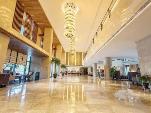 an empty lobby with a large building with a chandelier at Suzhou Qingshan Conference Center in Suzhou