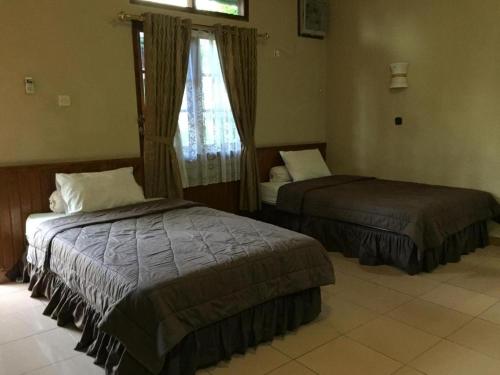 Кровать или кровати в номере Hotel Bunga Pantai