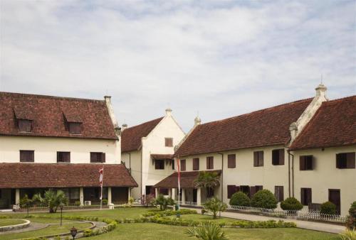 a row of white buildings with red roofs at Wisma Jampea in Makassar