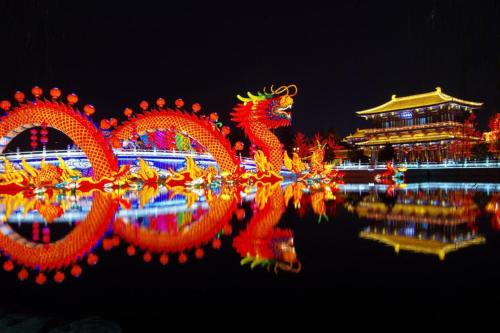 a group of chinese dragons in the water at night at James Joyce Coffetel Xian Big Goose Pagoda Tang Paradise Branch in Xi'an