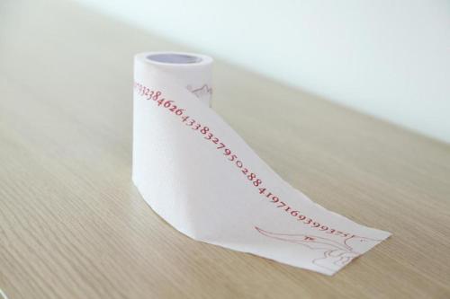 a roll of toilet paper sitting on a table at PAI Hotels·Shijiazhuang Development Zone Tianshan Science and Technology Park in Shijiazhuang