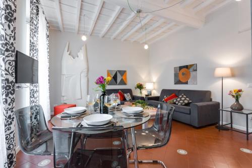 a living room with a glass table and a couch at Rome as you feel - Grotta Pinta apartments in Rome