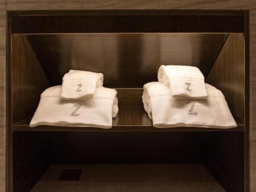 a group of towels sitting on a shelf at Zmax Qingyuan Yiwu Trade City in Qingyuan