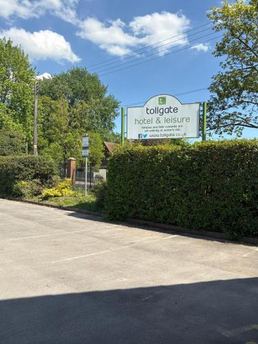 a sign for a motel and refuge in a parking lot at Tollgate Hotel & Leisure in Stoke on Trent