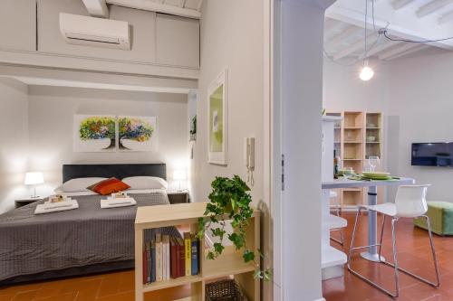 a bedroom and living room with a bed and a kitchen at Rome as you feel - Grotta Pinta apartments in Rome