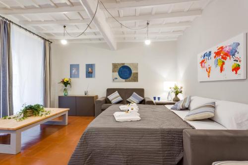 a living room with a large bed and a couch at Rome as you feel - Grotta Pinta apartments in Rome