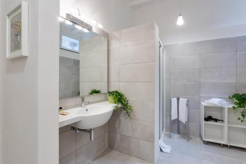 a bathroom with a sink and a mirror at Rome as you feel - Grotta Pinta apartments in Rome