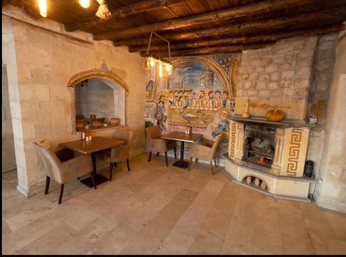 a living room with a table and a fireplace at Onur Cave Cappadocia in Goreme