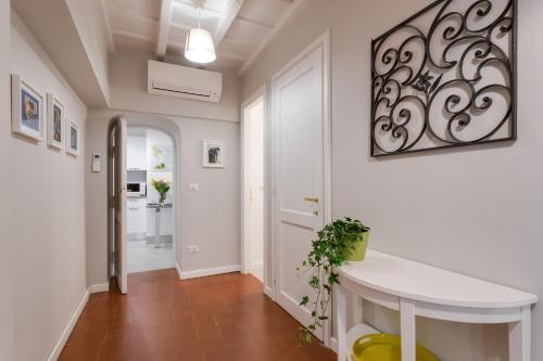 a hallway with a white table in a room at Rome as you feel - Grotta Pinta apartments in Rome