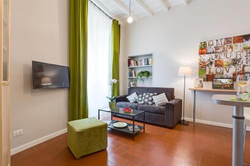 a living room with a couch and a tv at Rome as you feel - Grotta Pinta apartments in Rome