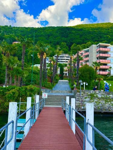 a bridge over a body of water with stairs and buildings at MIRALAGO -Wonderful Lake view in Bissone