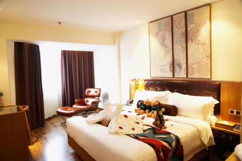 a hotel room with a bed with a stuffed animal on it at James Joyce Coffetel· Hefei Anhui Agricultural University in Hefei