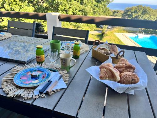 a picnic table with pastries and drinks on it at Campuleccia in Lumio