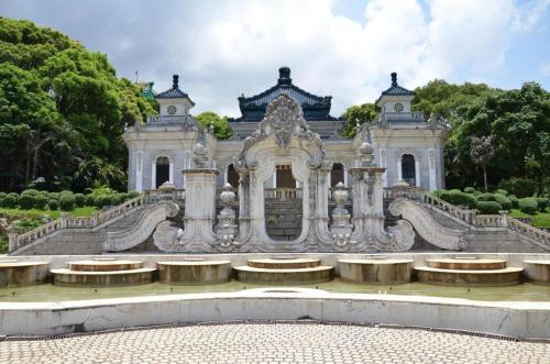 an old building with a fountain in front of it at Xana Hotelle Zhuhai Gongbei Port in Zhuhai