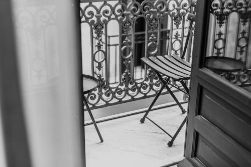 a balcony with a chair and a fence at Palazzo Villelmi in Cefalù