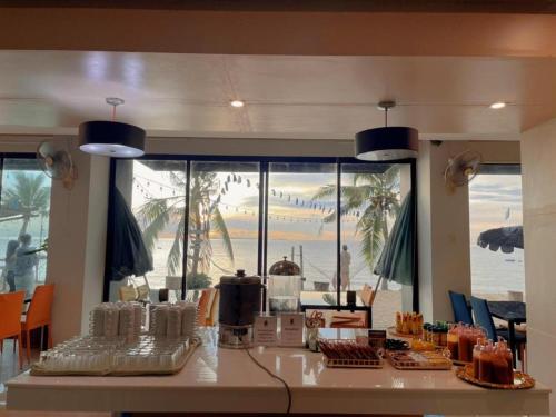 a kitchen with a counter with a view of the ocean at Golden Dragon Beach Resort Pattaya (Bang Lamung) in Ban Rong Po