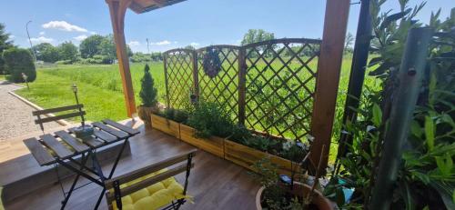 a patio with a fence with a table and benches at Charmdeen in Jastrebarsko