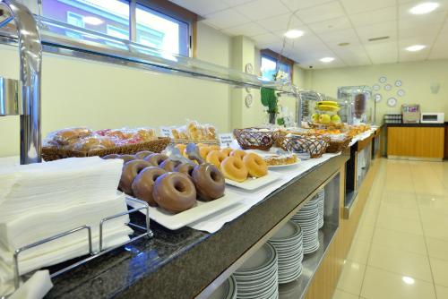 a bakery with a bunch of donuts on a counter at Hotel Norat Marina & Spa 4* Superior in O Grove