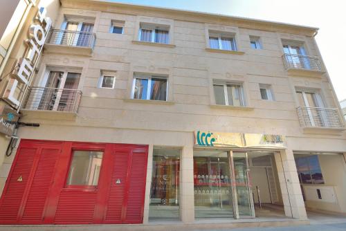 a building with red doors on the side of it at Hotel Norat Marina & Spa 4* Superior in O Grove
