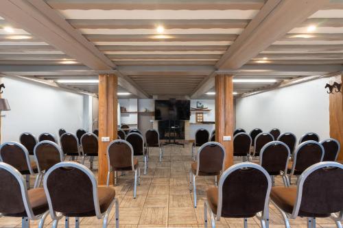 a row of chairs in a room with a podium at Eden Park Hotel Restaurant in Pont-lʼÉvêque