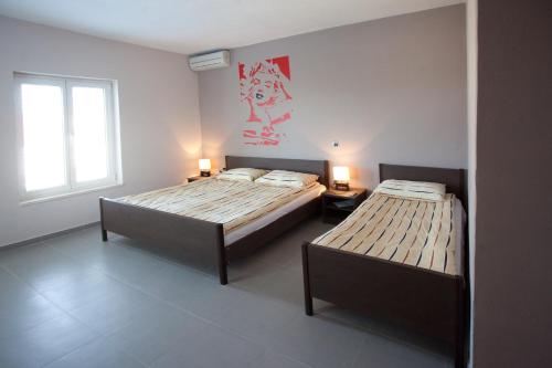a bedroom with two beds and a window at Villa Marijeta Hvar in Hvar