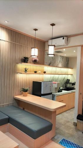a kitchen with a counter with two lights above it at Apartemen delipark tower lexington in Medan