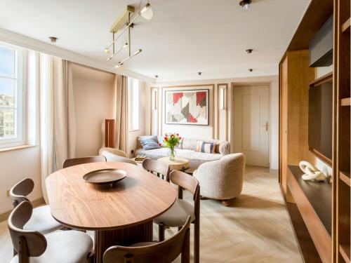 un salon avec une table et un canapé dans l'établissement Merveil - Signature Suite - Louvre - Bourse II, à Paris