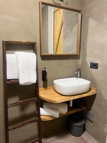 a bathroom with a sink and a mirror and towels at La Campanula in La Spezia