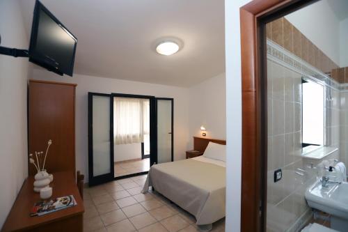Ένα ή περισσότερα κρεβάτια σε δωμάτιο στο Residence Club Solemare