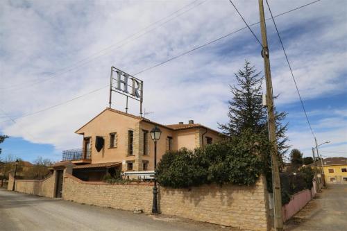 a house with a large sign on top of it at Hotel Rural Los Abriles in El Toro