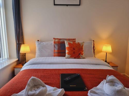 a bedroom with a bed with a book on it at The Cameo in Blackpool