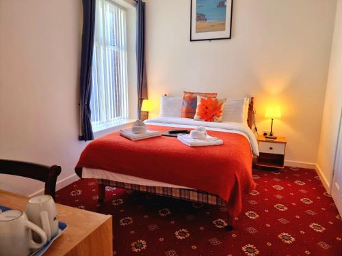 a bedroom with a bed and a red carpet at The Cameo in Blackpool