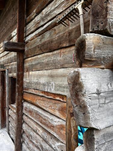 a wooden wall of a building with a statue on it at Grange de Fonville - Evolène - Valais in Evolène