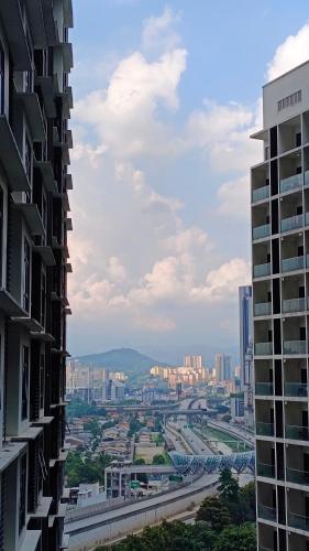 a view of a city from between two buildings at Summer Suites KLCC by CozyNest in Kuala Lumpur