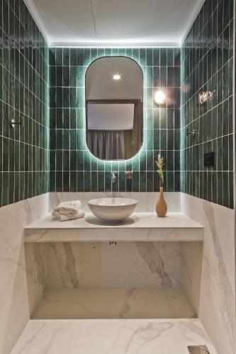 a bathroom with a sink and a mirror at Arcus Luxury Suites Karpathos in Karpathos Town