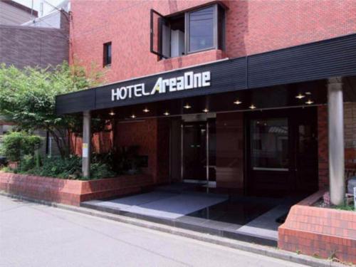 a hotel entrance with a sign on a building at Hotel Areaone Miyazaki in Miyazaki
