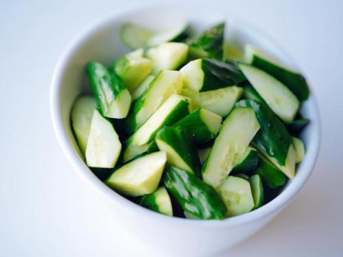 a white bowl filled with cucumbers and greens at Hotel Areaone Miyazaki in Miyazaki