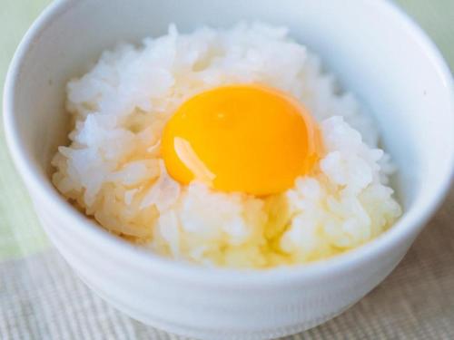 a bowl of rice with an egg in it at Hotel Areaone Miyazaki in Miyazaki
