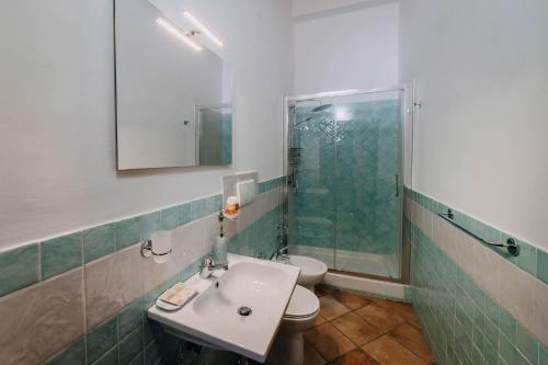 a bathroom with a sink and a shower and a toilet at Tenuta Le Tre Rose in Vibonati