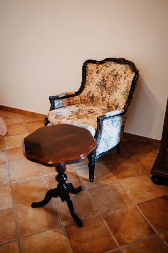 an old chair and a stool in a room at Tenuta Le Tre Rose in Vibonati