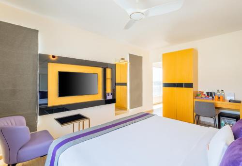 a hotel room with a bed and a tv at Zone Connect by The Park Coimbatore in Coimbatore